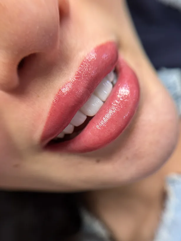 Glossy red lip blush close up