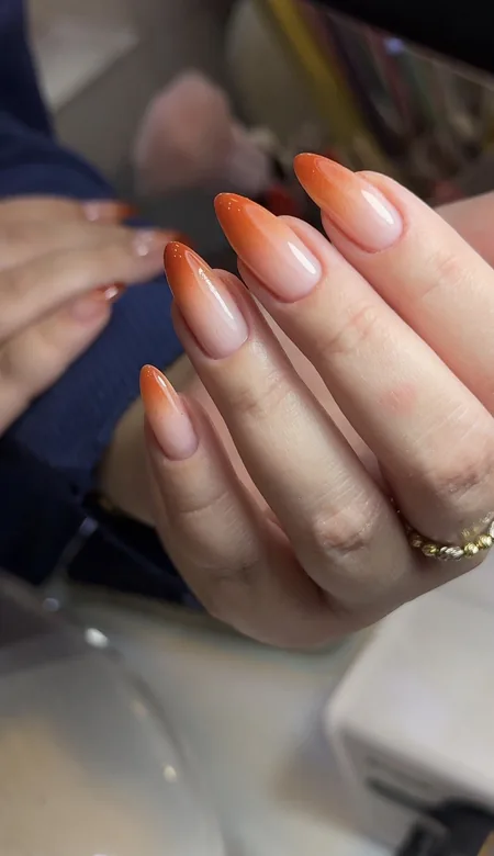 Nude to coral ombré almond nails